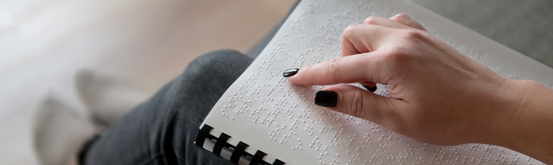 Picture of a woman reading Braille